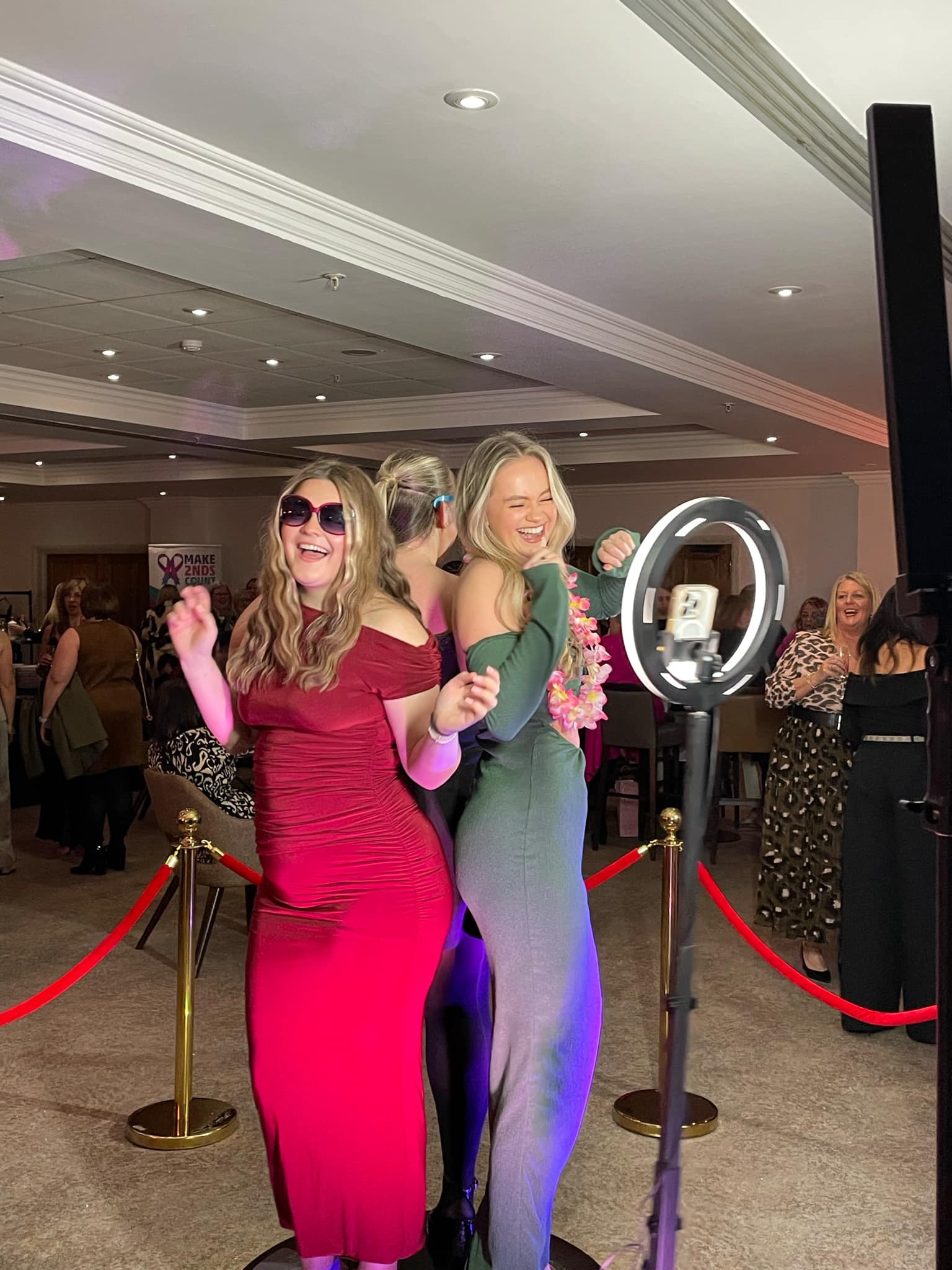 Guests enjoying the Rich Fox 360 Video Booth at a party with red carpet barriers